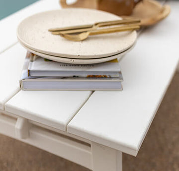 plate and books on a patio table top